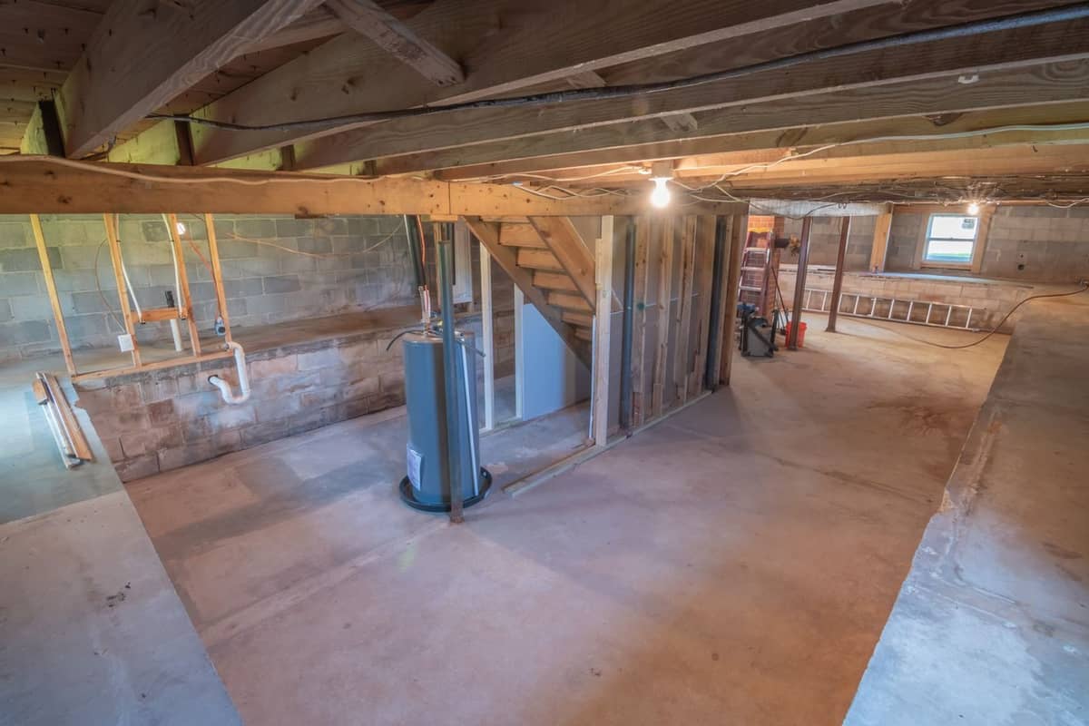 Exposed floor joists and subfloor seen from below in an unfinished space